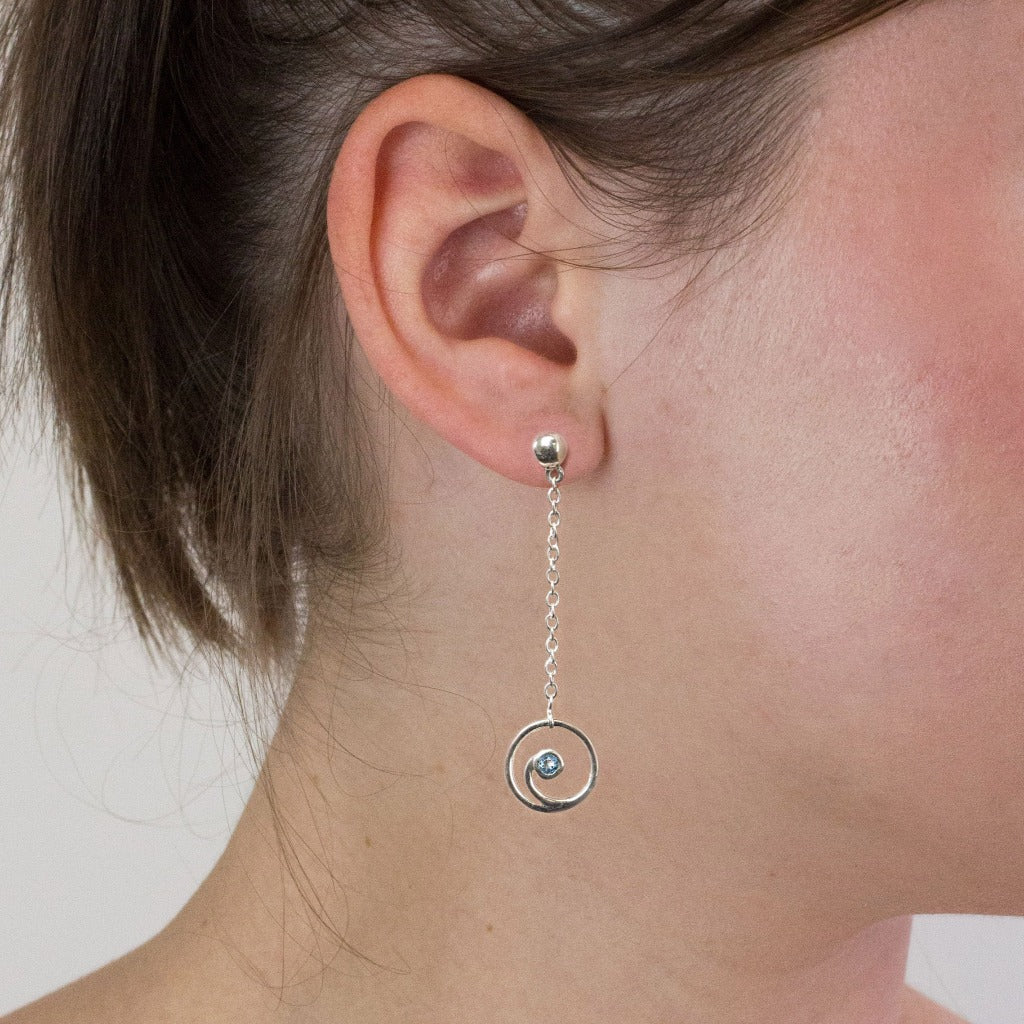 Blue Topaz stud drop earrings on model