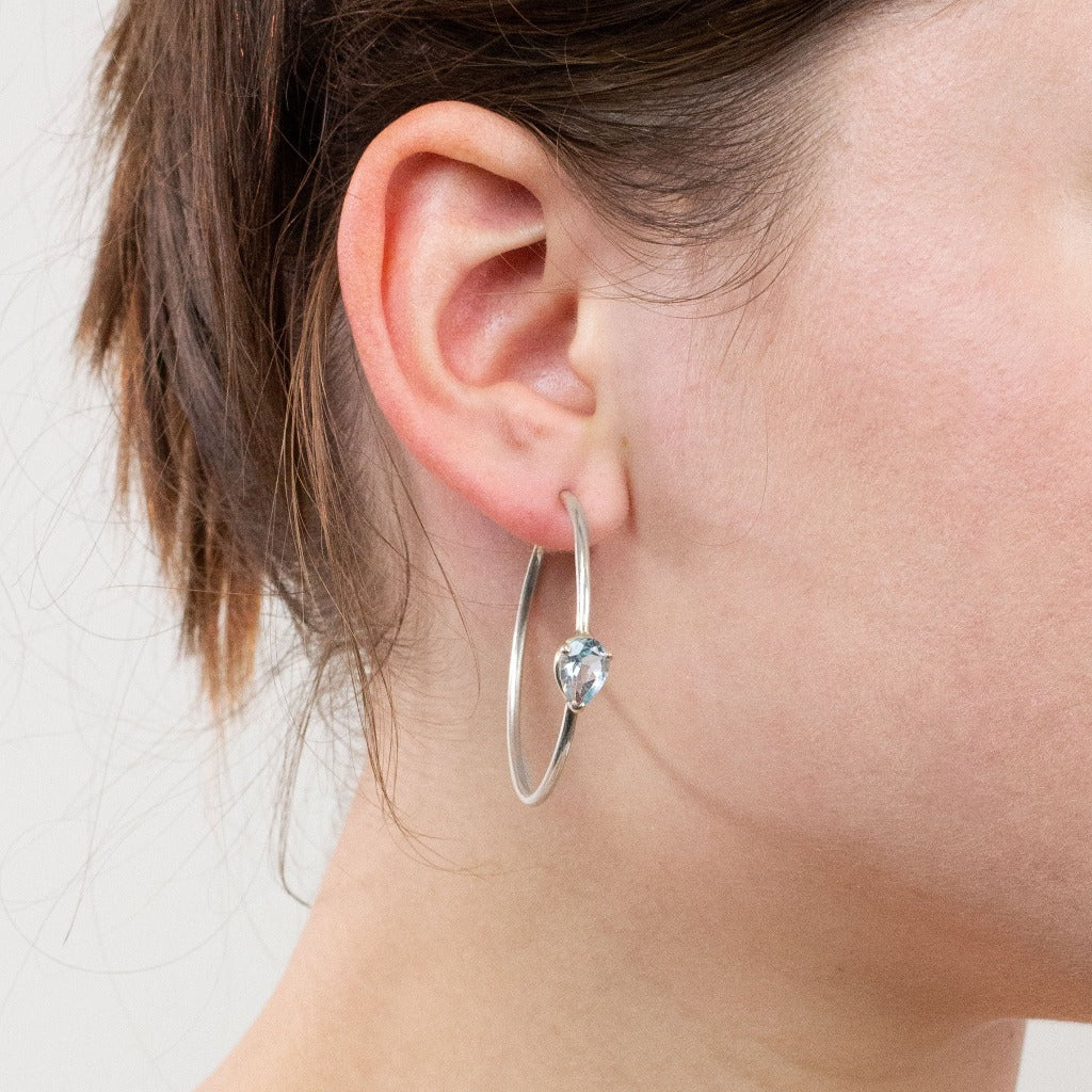 Blue Topaz hoops on model
