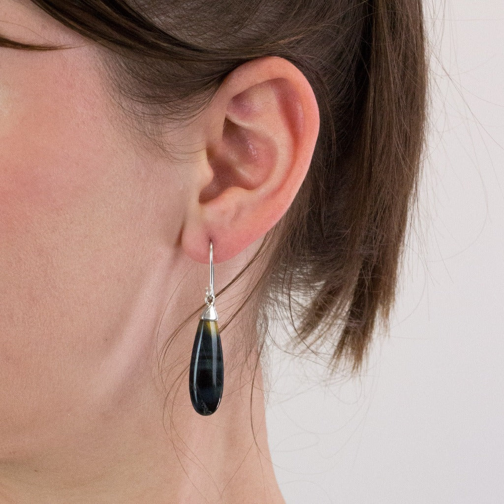 Hawks Eye drop earrings on model