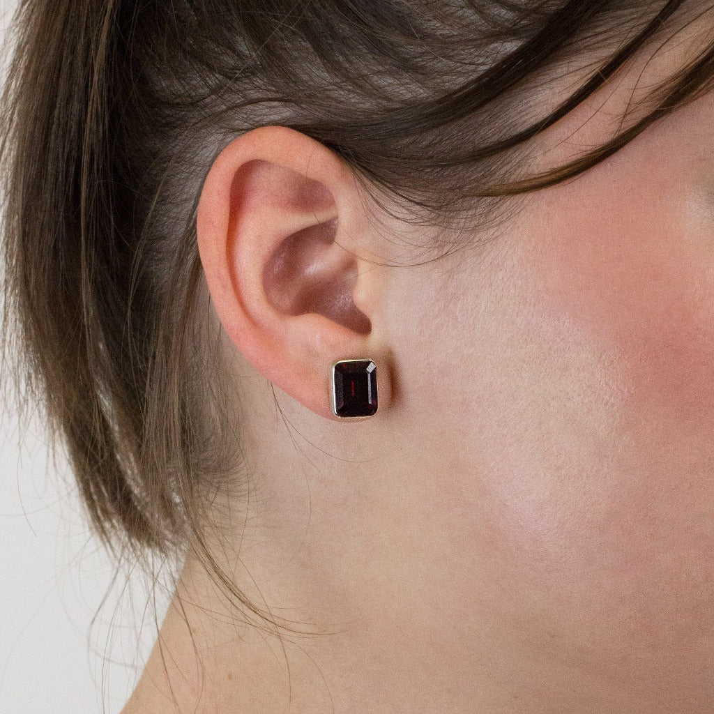 Garnet stud earrings on model