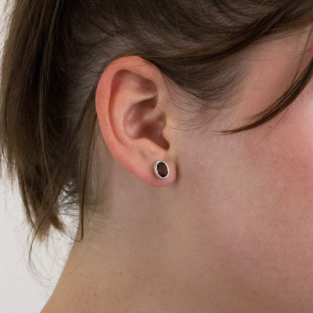 Garnet stud earrings on model