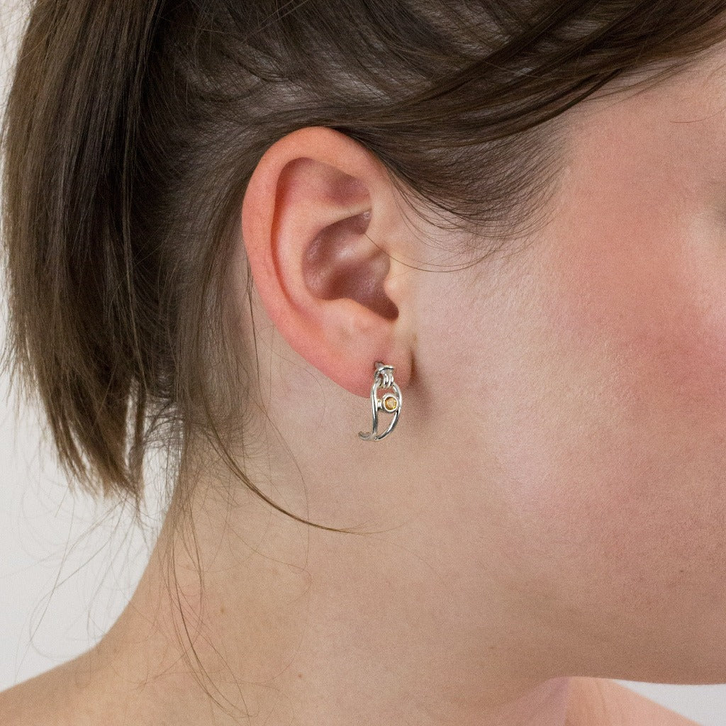 Citrine stud earrings on model