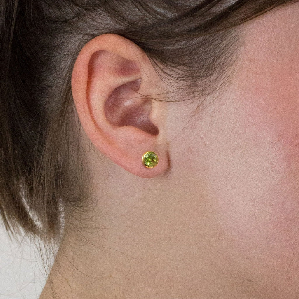 Peridot stud earrings on model