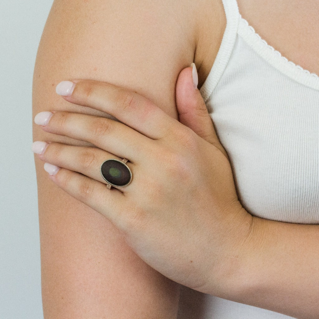 Cabochon Rainbow Obsidian ring on model