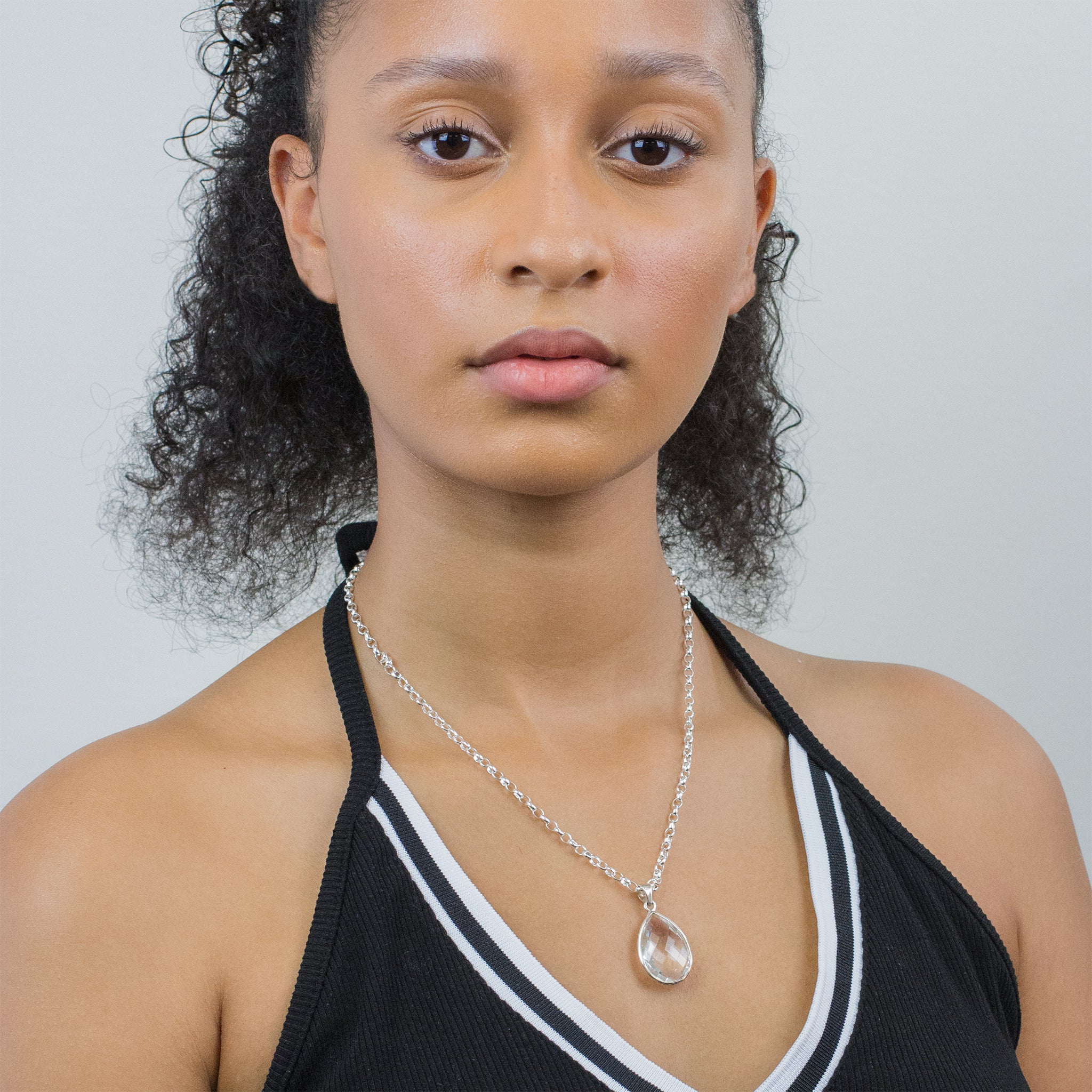 CLEAR QTZ FACETED TEAR PENDANT ON MODEL