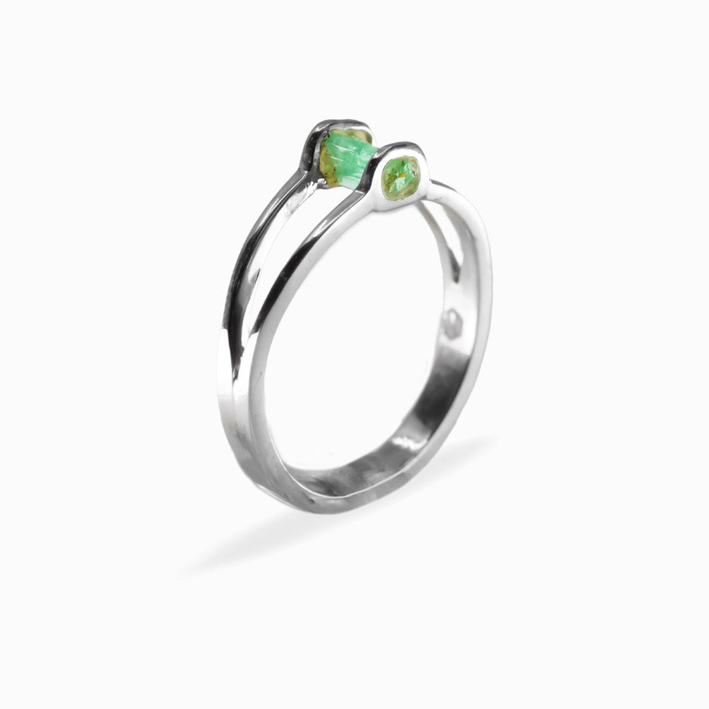 Raw rectangular green Emerald ring in polished 925 sterling silver with an open horizontal silver setting.