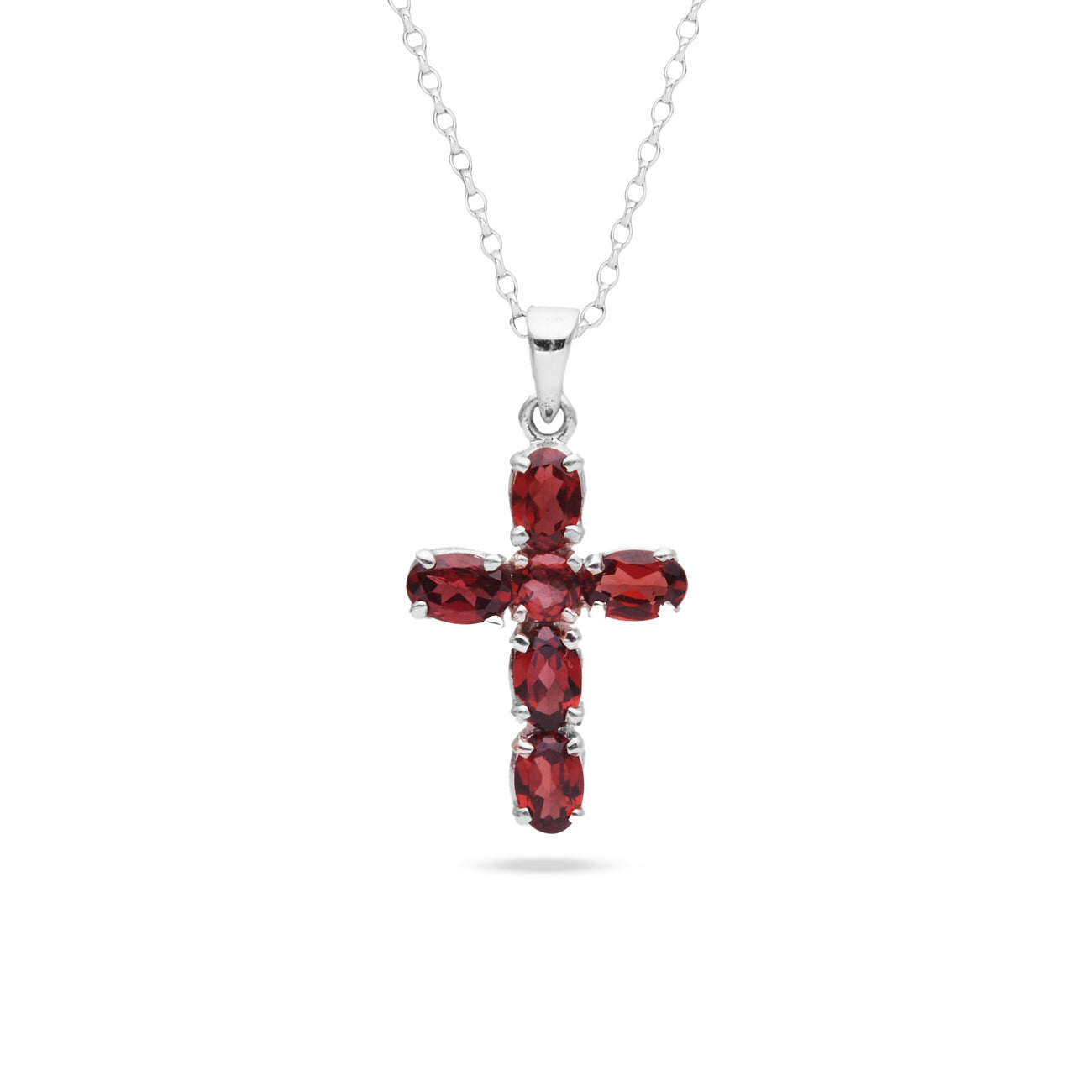 Cross-shaped pendant with red gemstones on a white background
