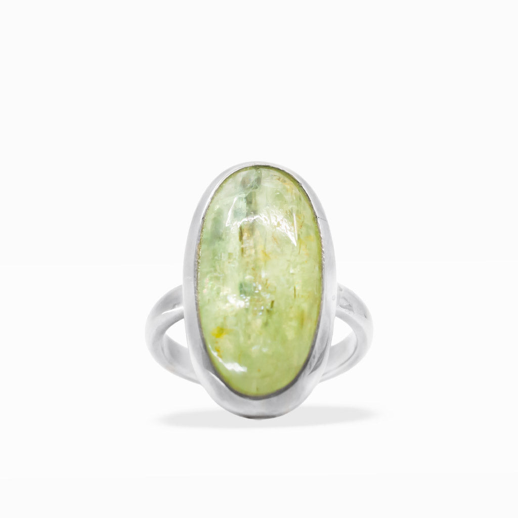 Pale green translucent oval Green Kyanite cabochon ring with natural inclusions, sterling silver bezel, and split band.