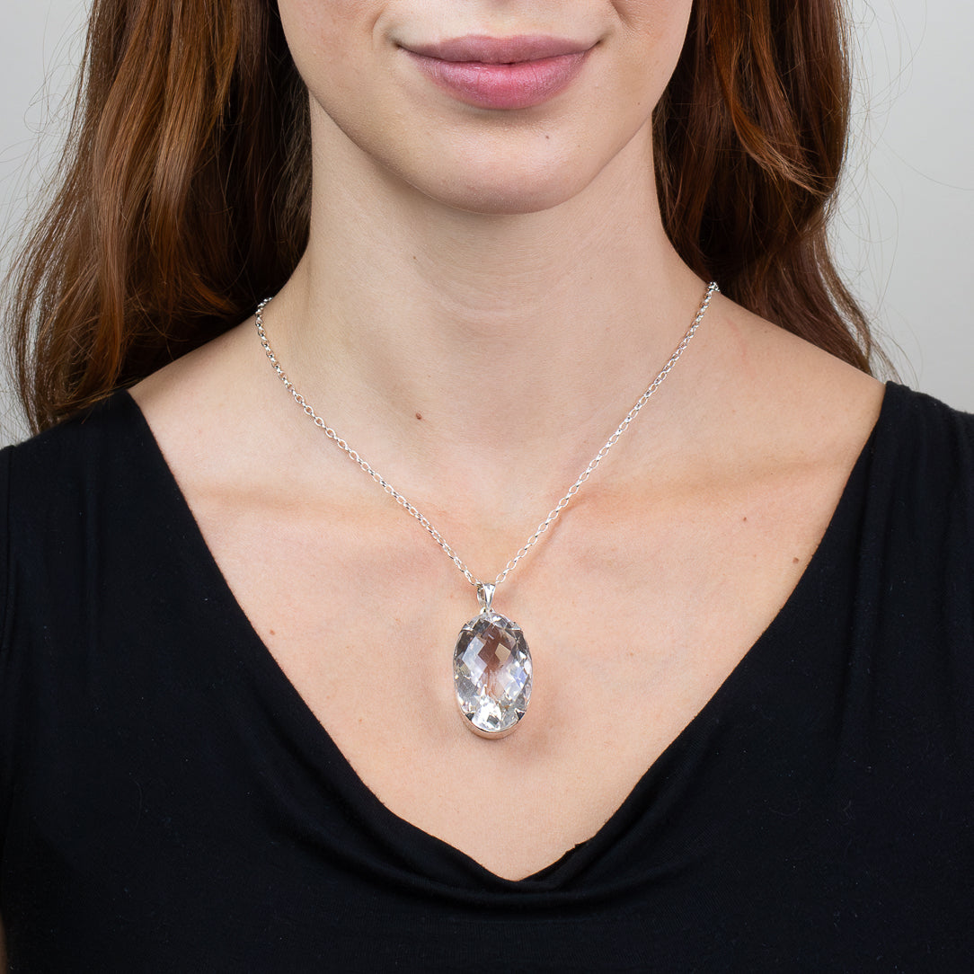 Faceted oval Clear Quartz pendant necklace in sterling silver featuring a transparent natural crystal gemstone.