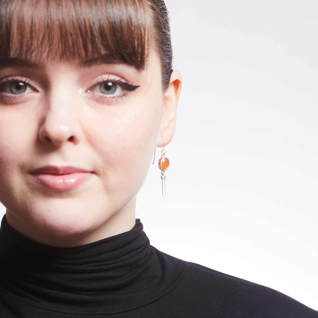 FACETED OVAL CARNELIAN AND LASER QUARTZ EARRINGS ON MODEL | MADE IN EARTH