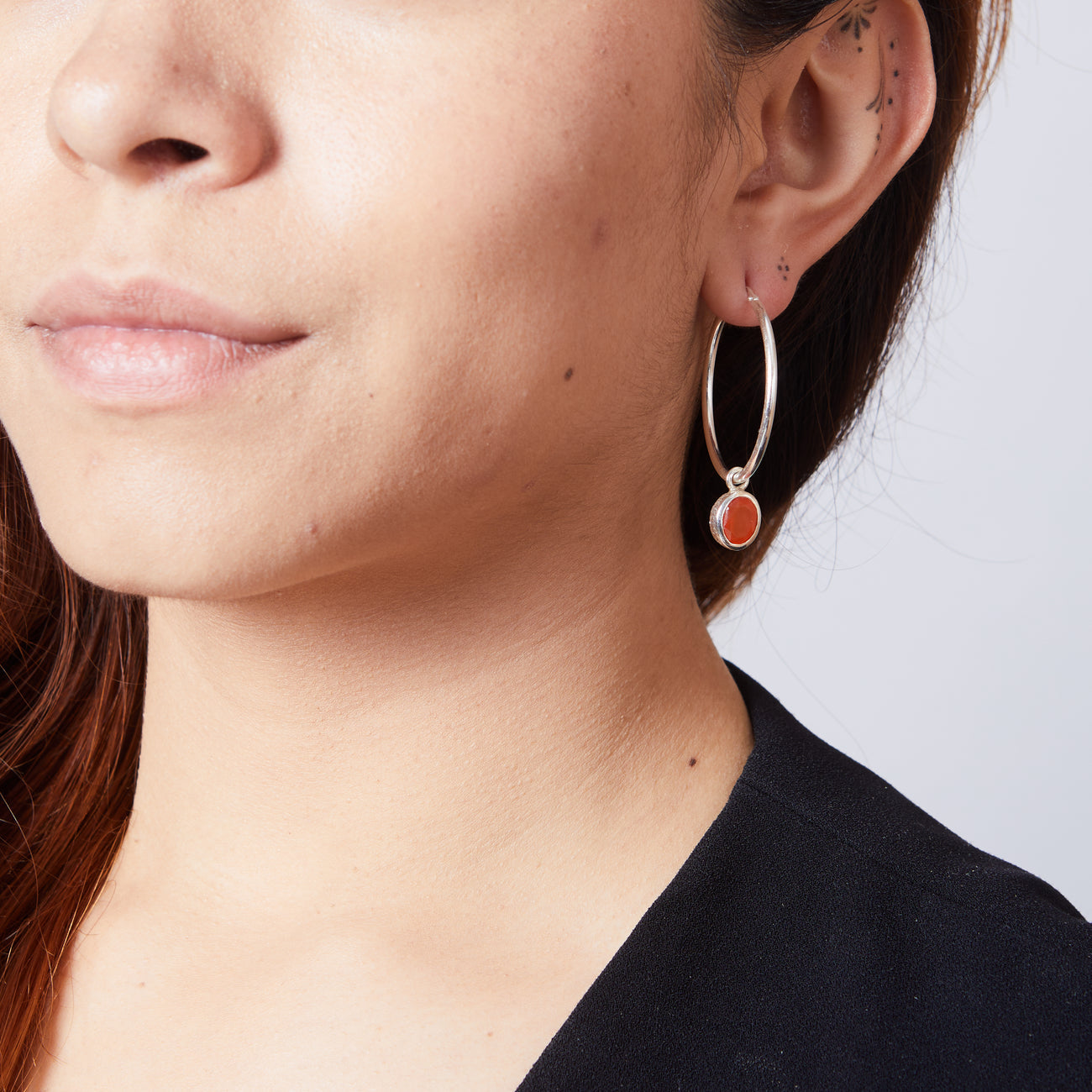 FACETED CARNELIAN HOOP CHARMS ON MODEL | MADE IN EARTH