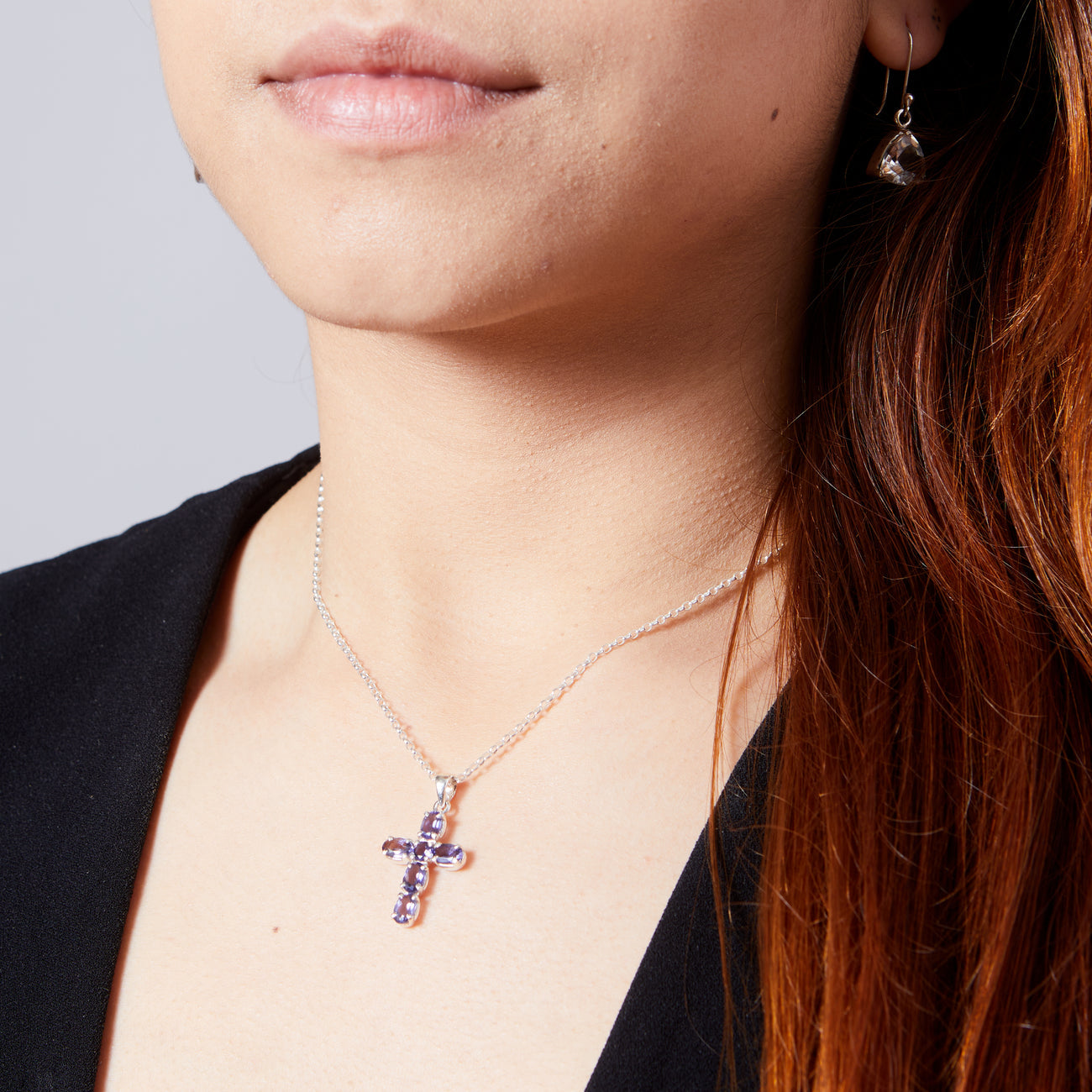Iolite cross-shaped pendant on model sterling silver