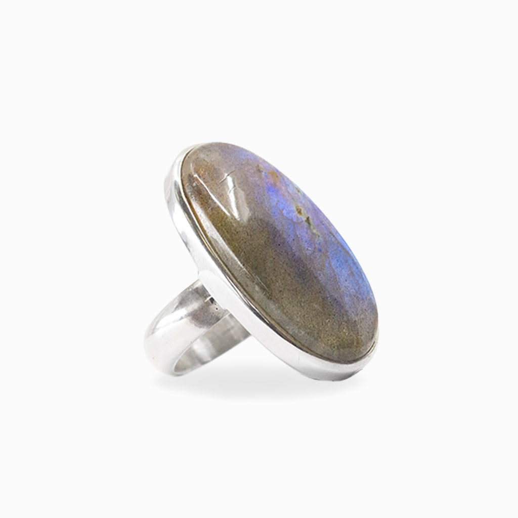 Elongated oval Labradorite cabochon with vivid blue flash set in polished 925 sterling silver.