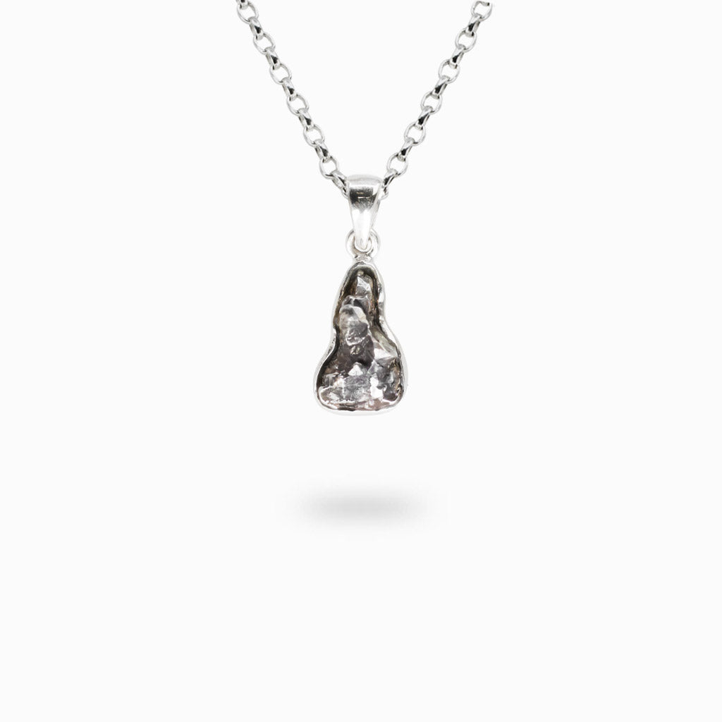 Natural Campo del Cielo Meteorite fragment with textured metallic surface handcrafted into a sterling silver pendant.