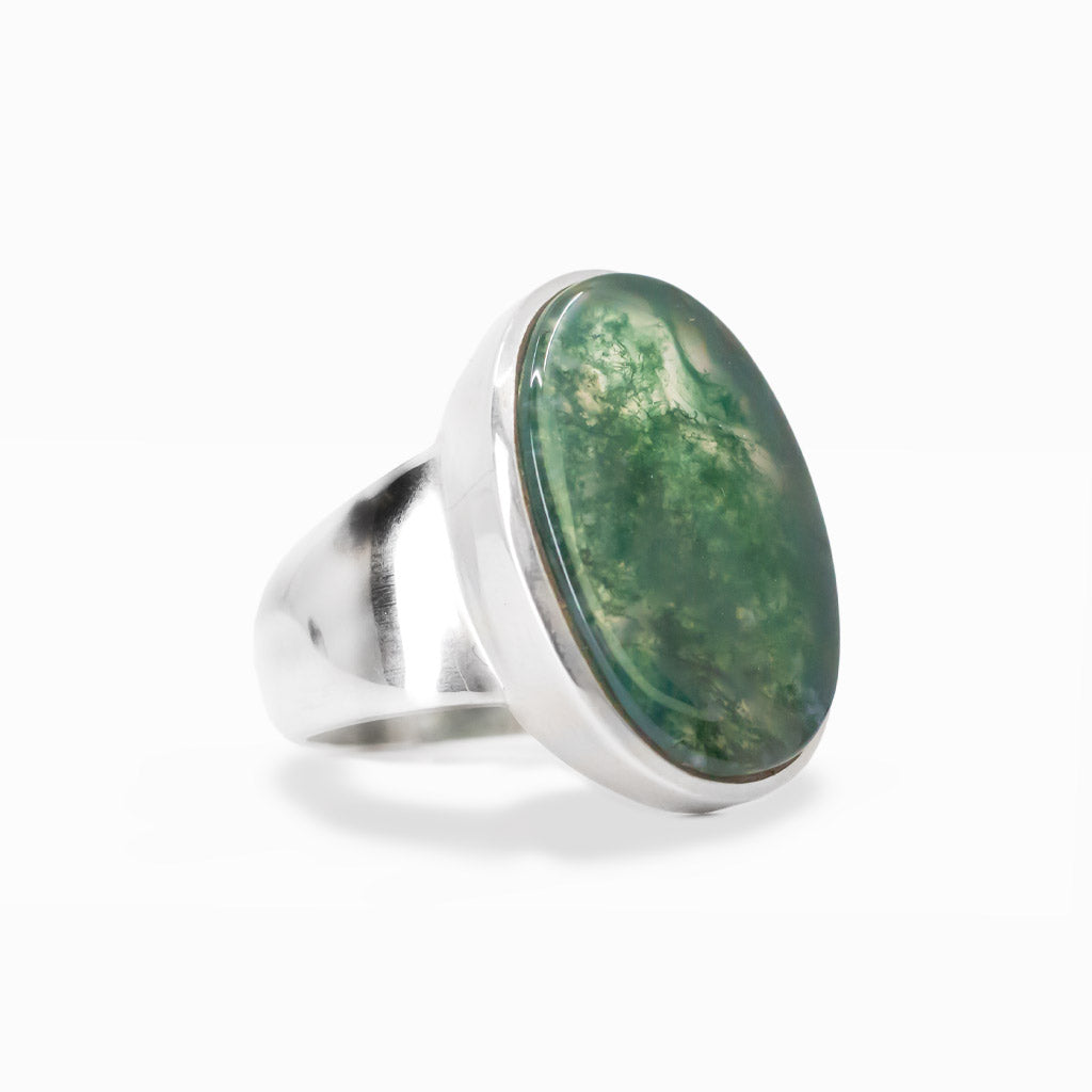 Oval Moss Agate cabochon sterling silver statement ring with natural green moss-like inclusions.