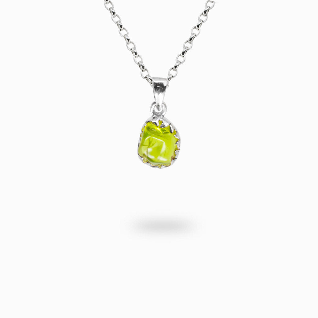 Bright lime green natural Peridot gemstone held in an organic sterling silver claw setting on a silver chain.