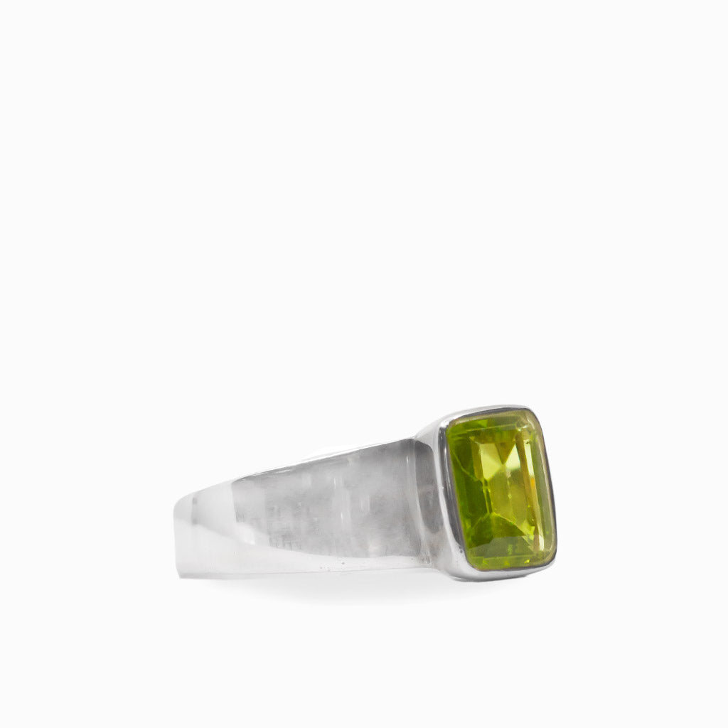 Vibrant green rectangular faceted Peridot gemstone bezel set in a polished 925 sterling silver ring.