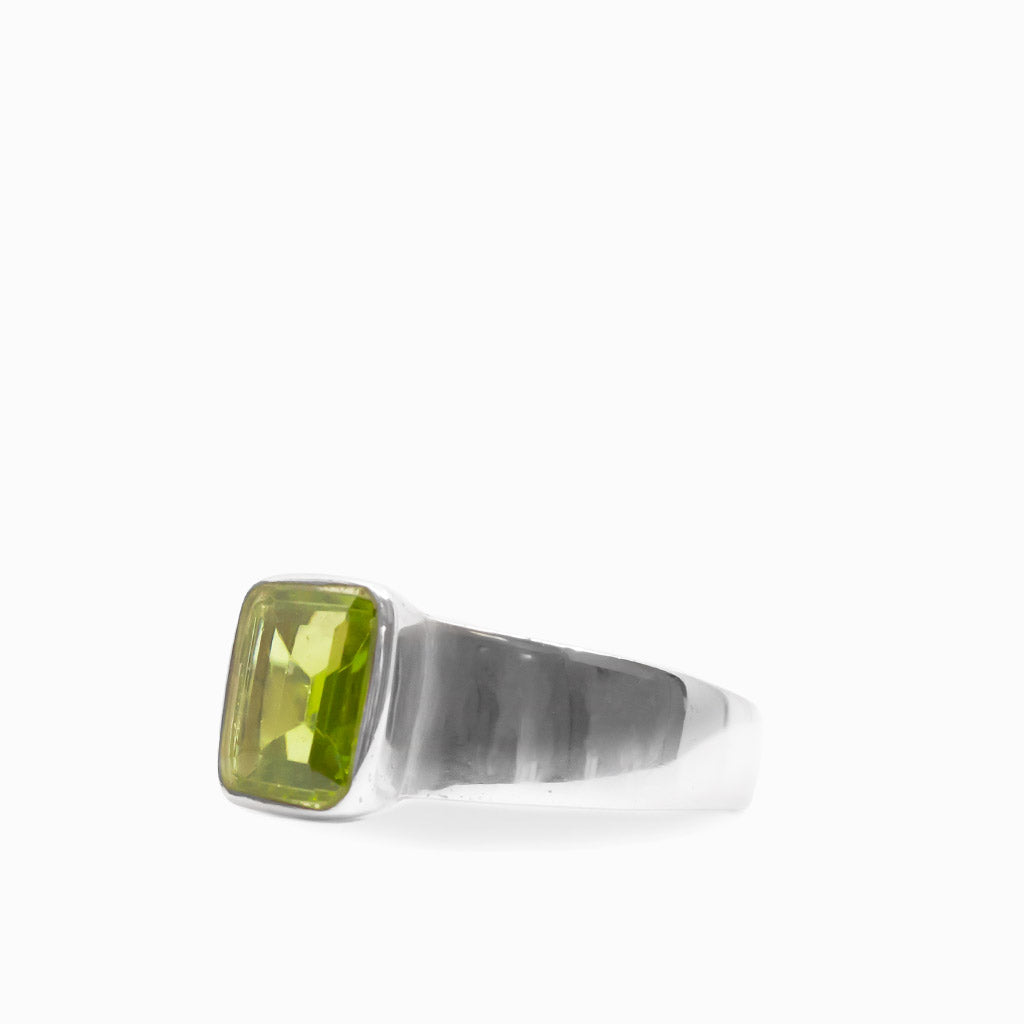 Vibrant green rectangular faceted Peridot gemstone bezel set in a polished 925 sterling silver ring.