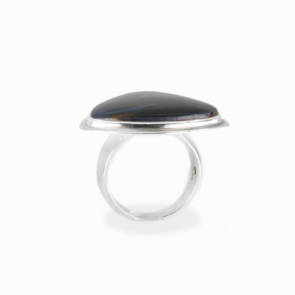 Pietersite triangular cabochon ring in polished sterling silver with swirling navy blue, electric blue and golden-brown natural patterns.