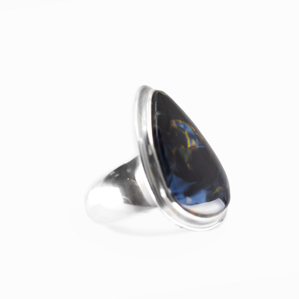 Pietersite triangular cabochon ring in polished sterling silver with swirling navy blue, electric blue and golden-brown natural patterns.