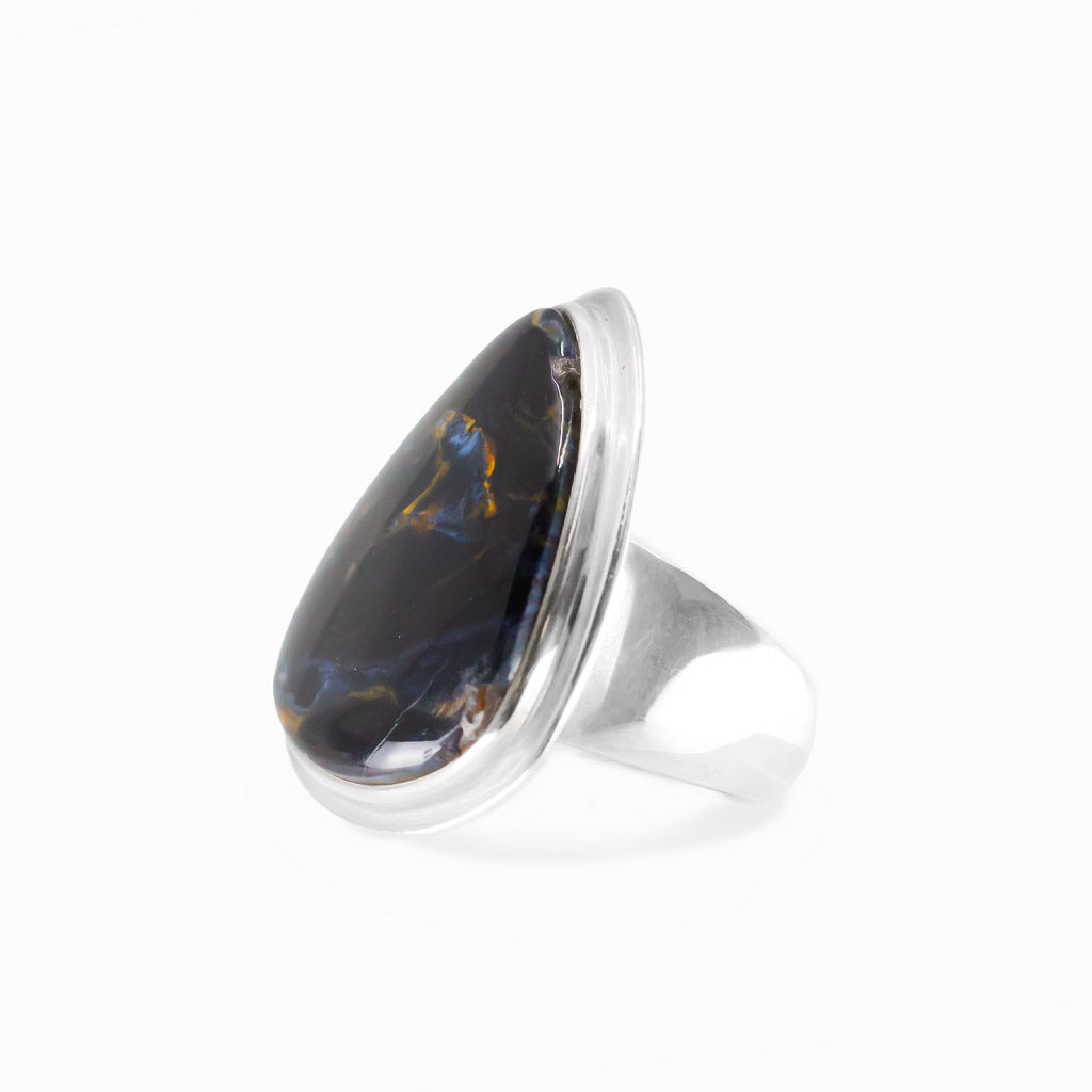 Pietersite triangular cabochon ring in polished sterling silver with swirling navy blue, electric blue and golden-brown natural patterns.