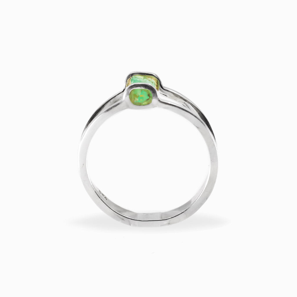 Raw rectangular green Emerald ring in polished 925 sterling silver with an open horizontal silver setting.