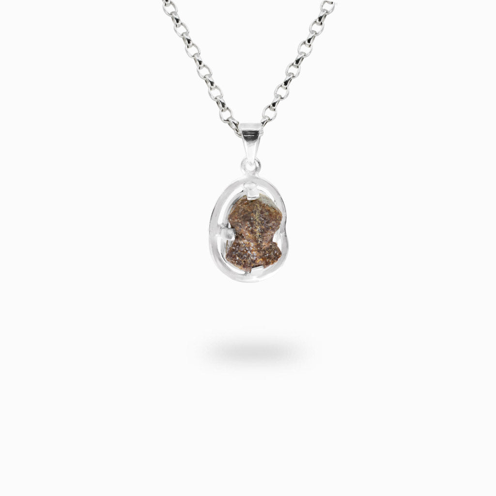 Natural brown raw Staurolite crystal held within an organic open sterling silver pendant setting.