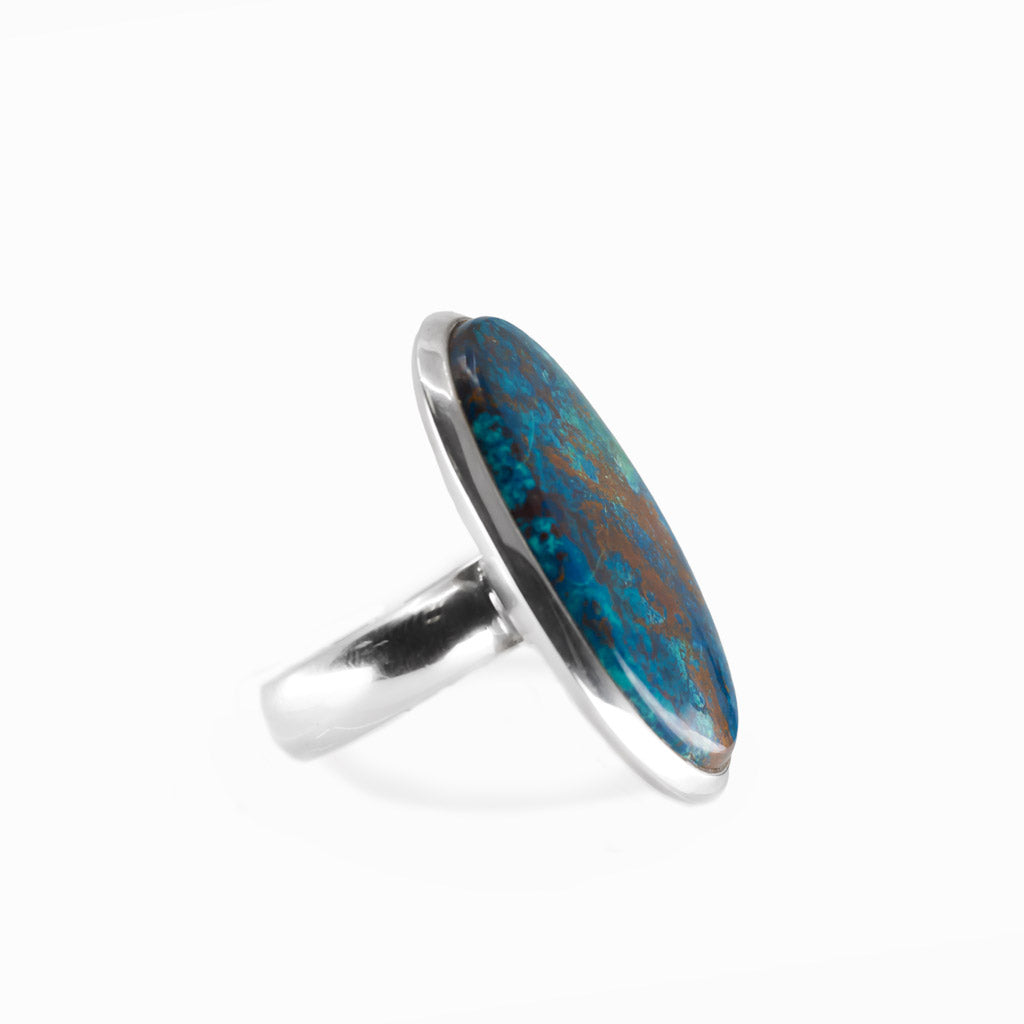 Shattuckite elongated oval cabochon ring in polished sterling silver with vivid turquoise blue and earthy copper-brown mineral patterns.