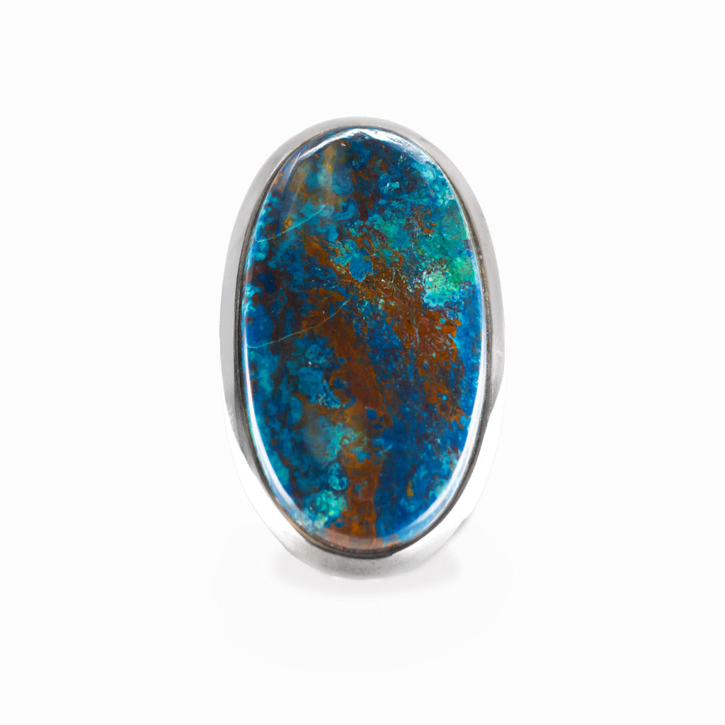Shattuckite elongated oval cabochon ring in polished sterling silver with vivid turquoise blue and earthy copper-brown mineral patterns.