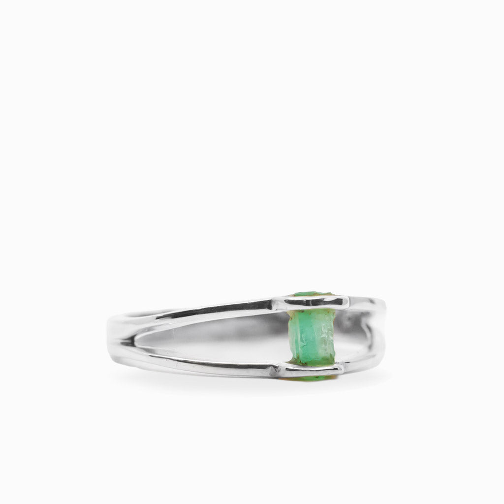 Raw rectangular green Emerald ring in polished 925 sterling silver with an open horizontal silver setting.