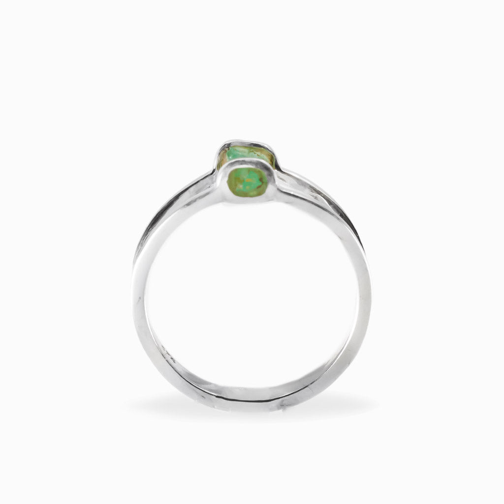Raw rectangular green Emerald ring in polished 925 sterling silver with an open horizontal silver setting.