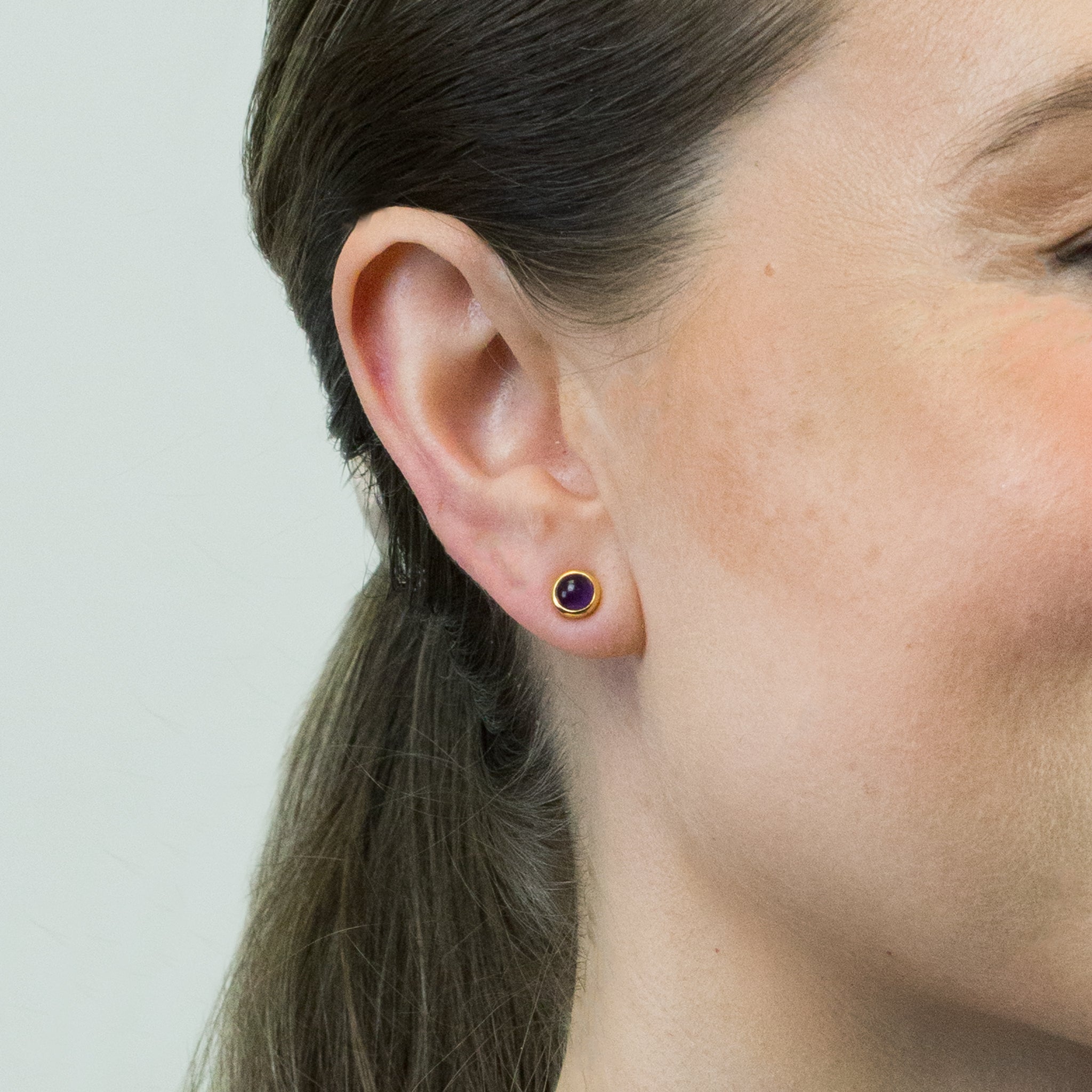 AMETHYST CABOCHON STUD EARRINGS WITH GOLD VERMEIL FINISH ON MODEL