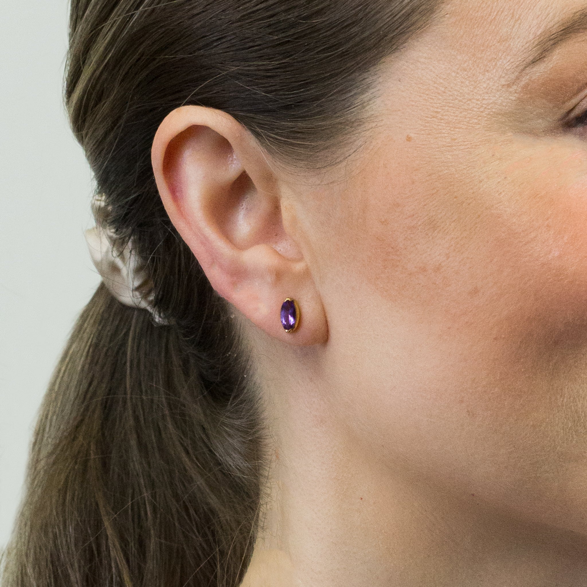 FACETED MARQUISE AMETHYST STUD EARRINGS WITH GOLD VERMEIL FINISH ON MODEL