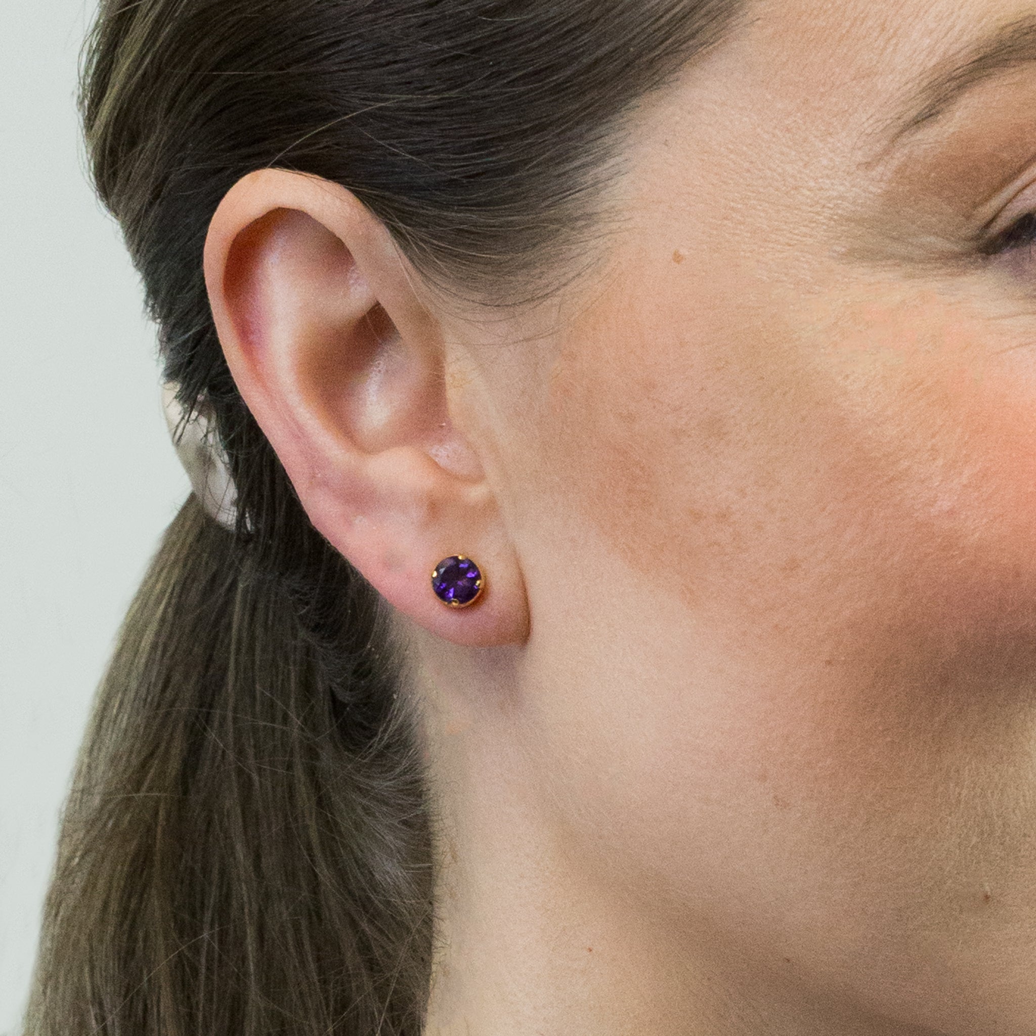 FACETED ROUND AMETHYST STUD EARRINGS WITH GOLD VERMEIL FINISH ON MODEL