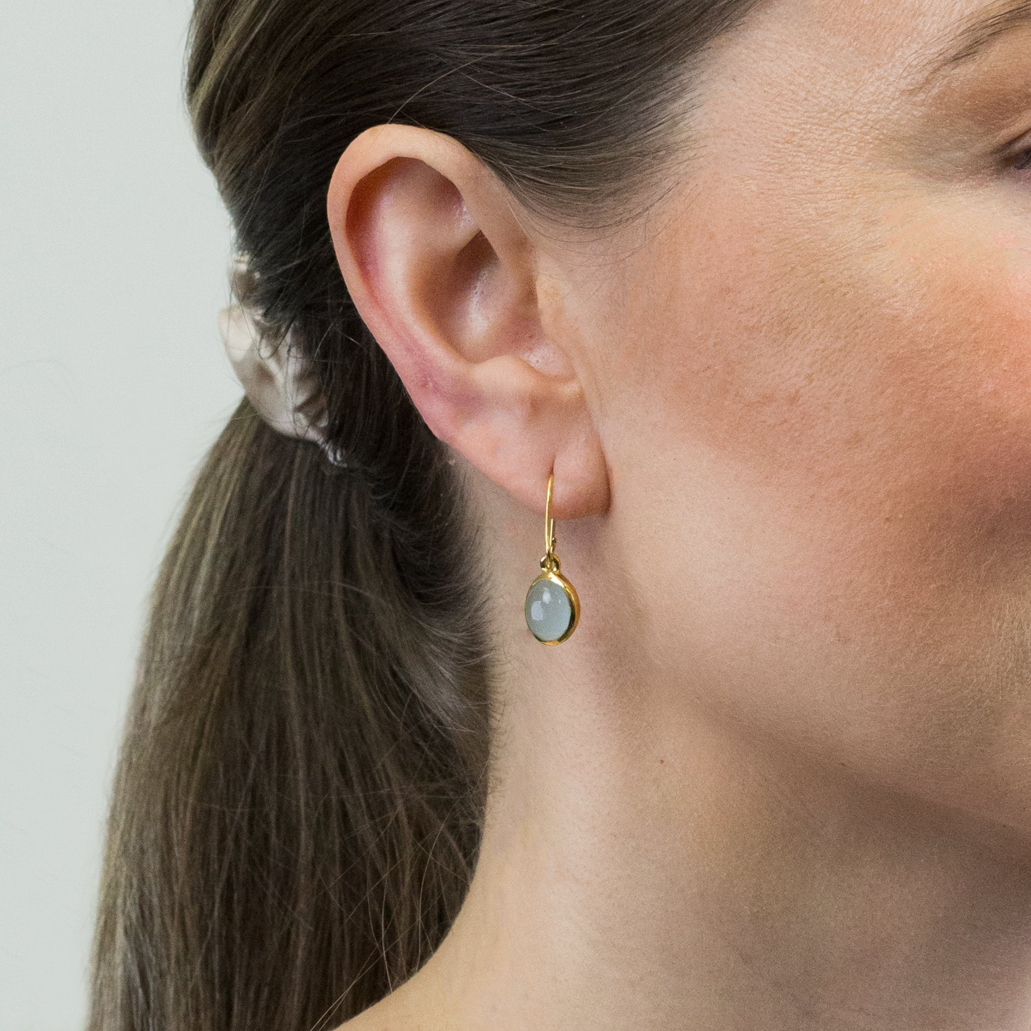 CABOCHON OVAL AQUAMARINE DROP EARRINGS WITH GOLD VERMEIL FINISH ON MODEL