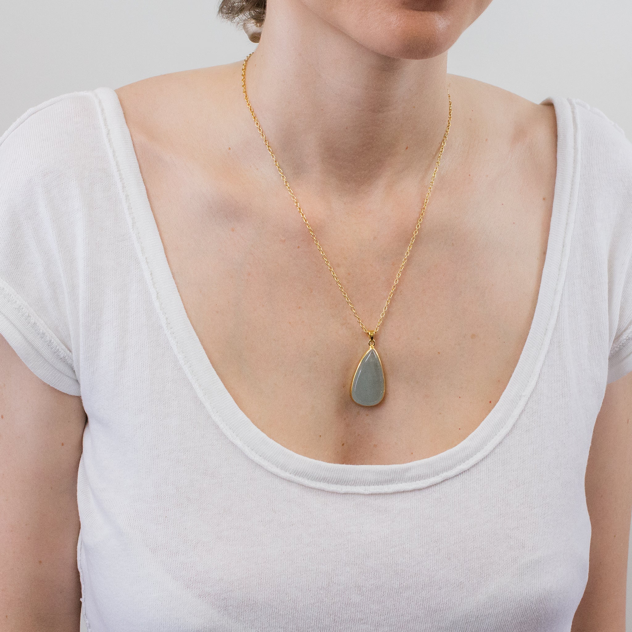 aquamarine cab tear necklace with gold vermeil finish on model