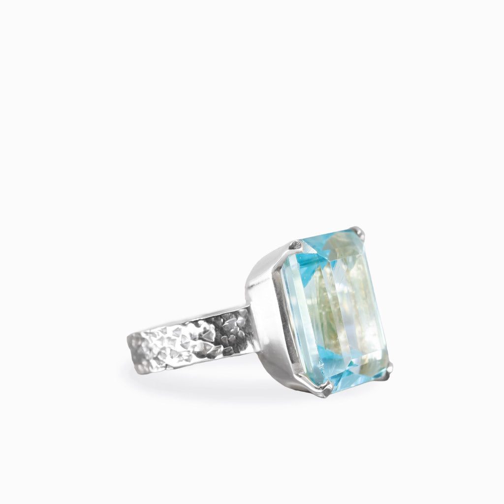 Faceted rectangular blue topaz ring in sterling silver