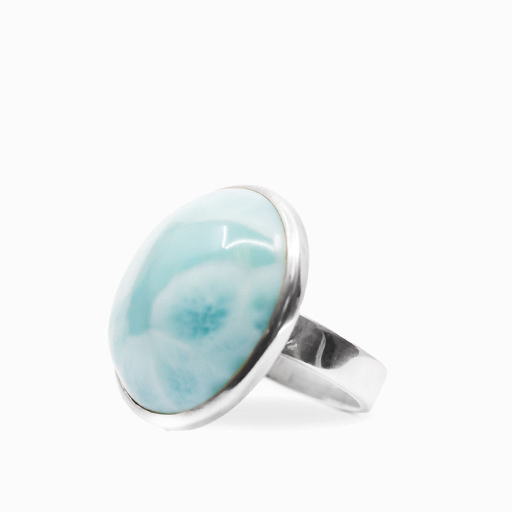 Rounded aqua-blue Larimar cabochon ring with white natural patterning in polished 925 sterling silver.