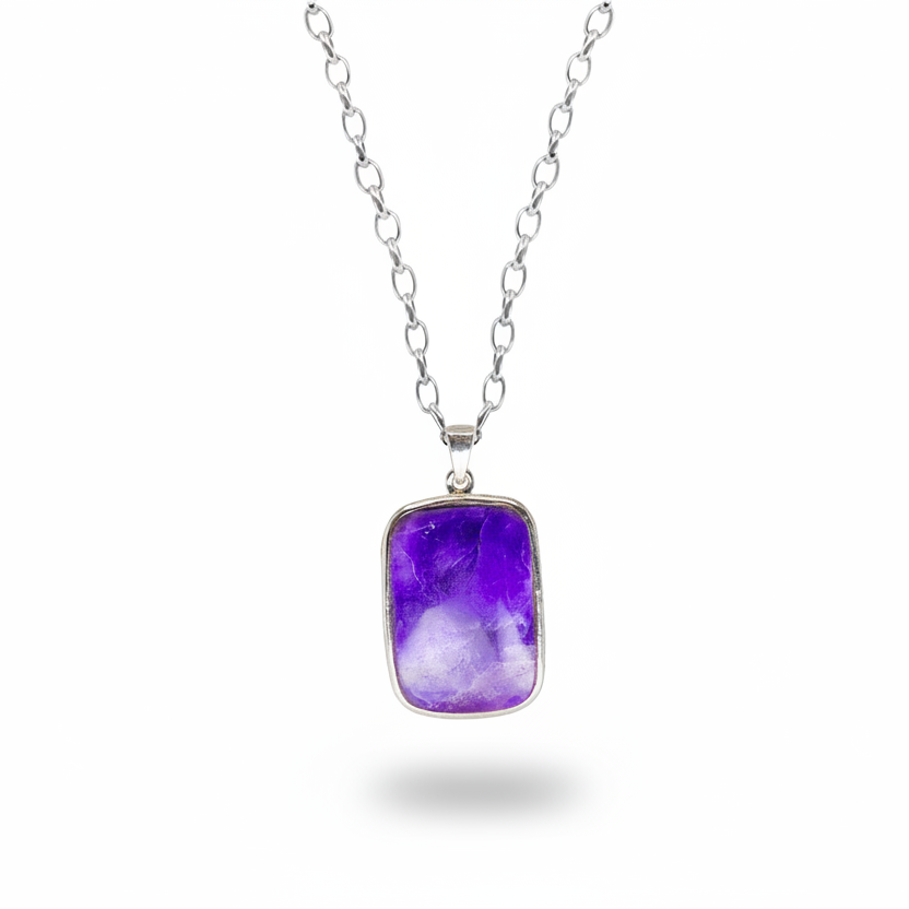 Rectangular sugilite cabochon pendant with vibrant purple tones in sterling silver