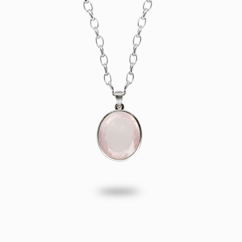 Faceted oval pale pink Rose Quartz pendant necklace in a polished sterling silver bezel setting.