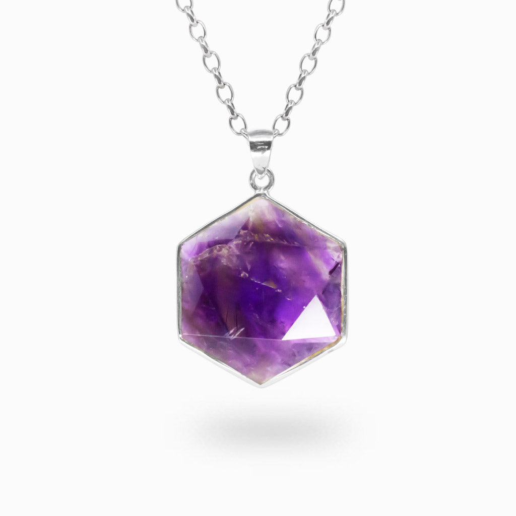 Hexagonal faceted purple Amethyst pendant with natural inclusions in a polished 925 sterling silver bezel setting.