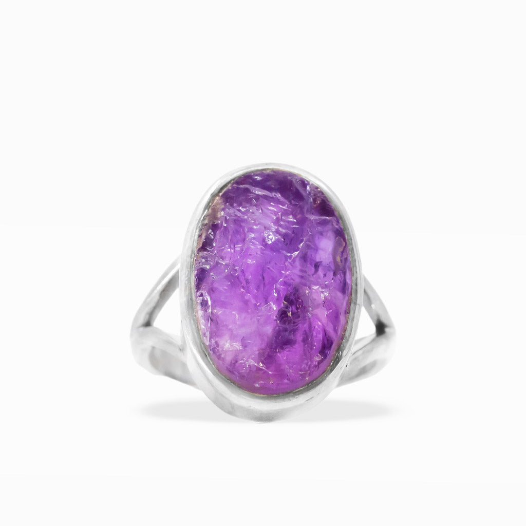 Raw purple Amethyst oval ring with natural crystalline inclusions, sterling silver bezel setting, and open split band.