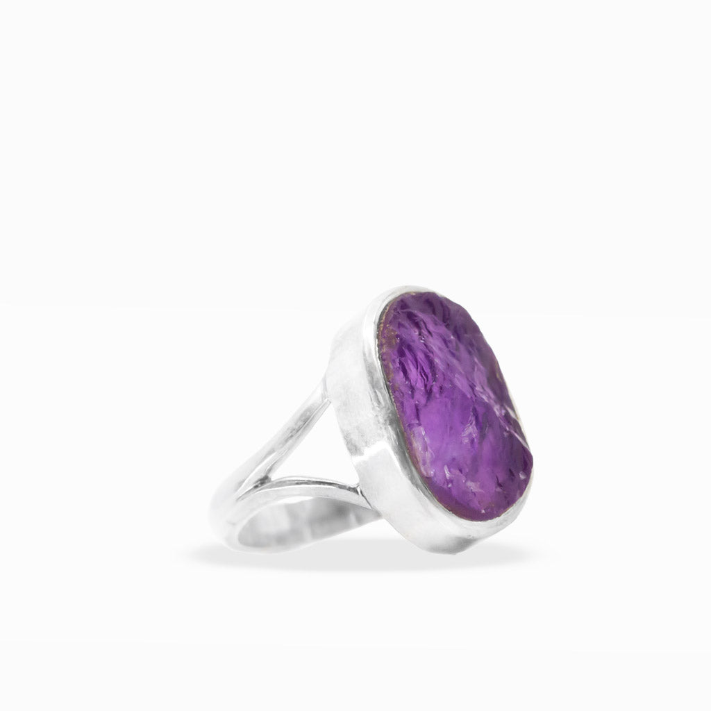 Raw purple Amethyst oval ring with natural crystalline inclusions, sterling silver bezel setting, and open split band.