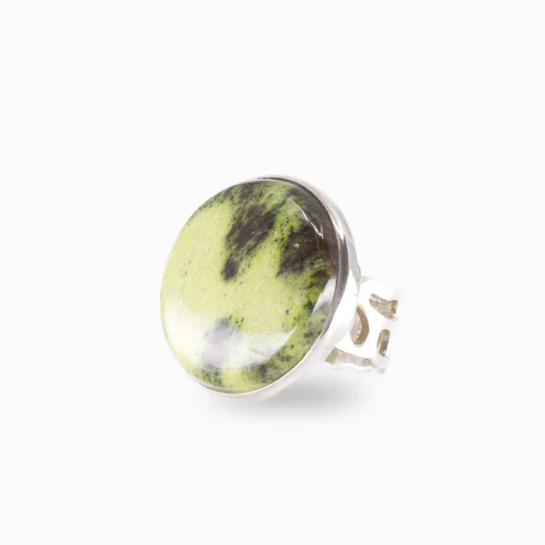 Serpentine gemstone ring with light green stone and natural dark inclusions set in silver