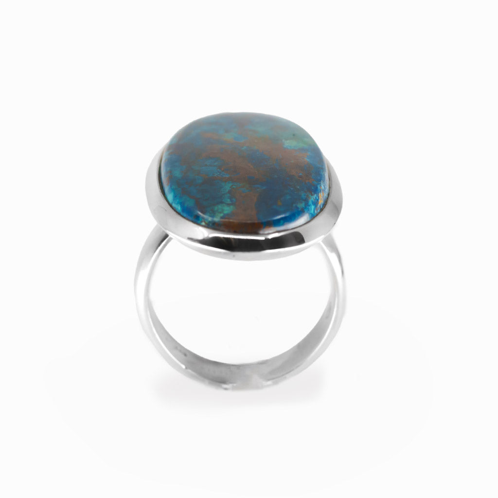 Shattuckite elongated oval cabochon ring in polished sterling silver with vivid turquoise blue and earthy copper-brown mineral patterns.