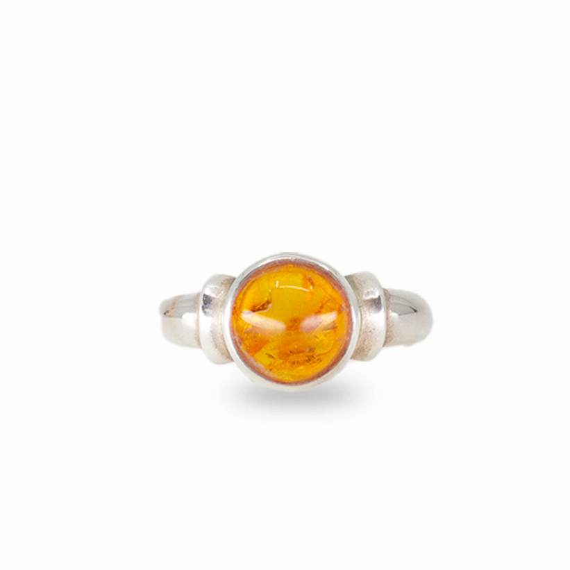 Round amber ring with warm golden fossilized resin set in sterling silver