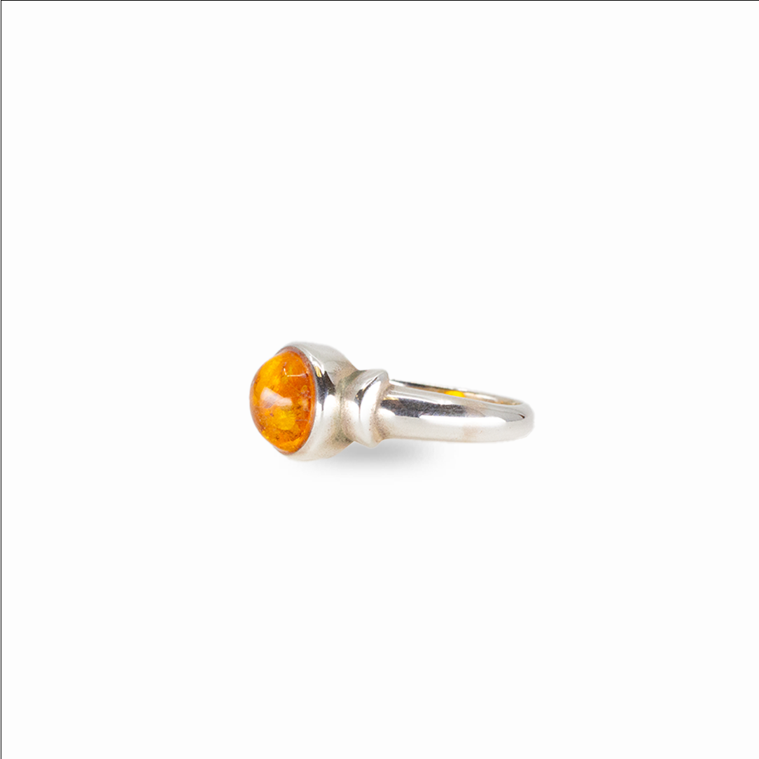 Round amber ring with warm golden fossilized resin set in sterling silver