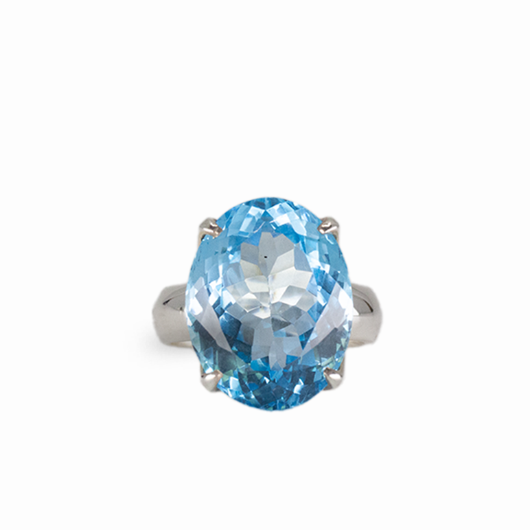 Oval blue topaz gemstone ring in sterling silver with brilliant electric blue color and prong setting