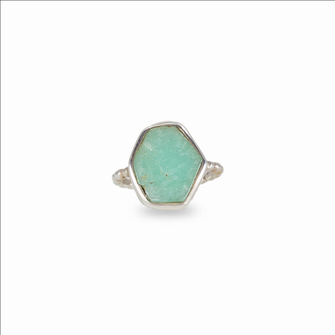 Raw emerald gemstone ring in sterling silver featuring vibrant green color and organic natural shape