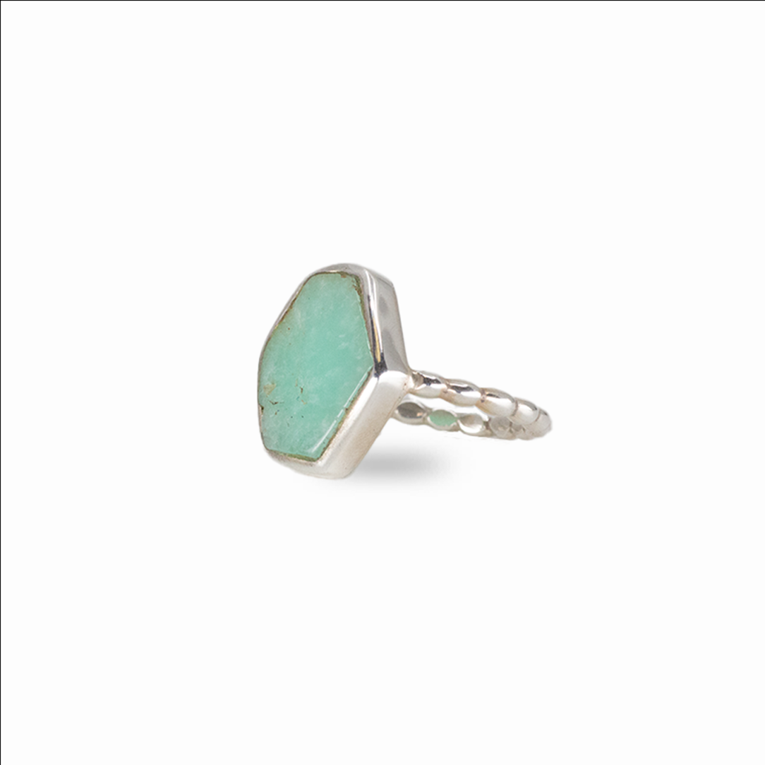 Raw emerald gemstone ring in sterling silver featuring vibrant green color and organic natural shape